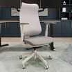 Cloud white Vari Align office chair with Alloy Grey mesh back and seat cushion, adjustable armrests, and five-caster base, shown in front of a wood desk with dual monitors.